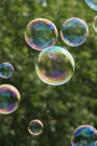 Blowing Soap Bubbles Highlighted Against Green Trees and a Blue Sky Journal: 150 Page Lined Notebook/Diary